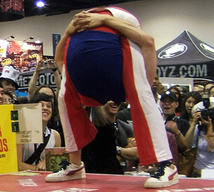 Rubberboy contorting with his head up his ass at ComicCon